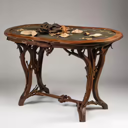 the table is made from wood and features leaves and flowers