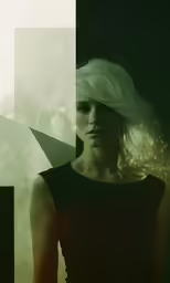 a woman with white hair posing in a dark room