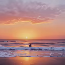 a surfer on a surfboard sits at the edge of the ocean as the sun rises