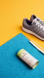 the shoe lace is next to a tube of sunscreen