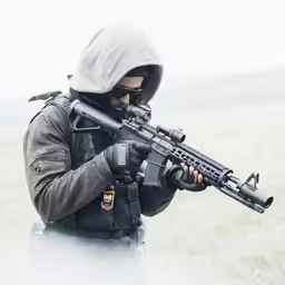 a man in the fog holding a rifle
