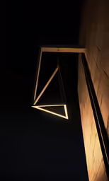 a light hanging from the ceiling over an object