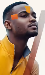a young man poses for the camera with his yellow geometrical shirt
