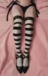 a woman laying on a bed in high heels
