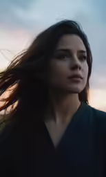 a woman is standing near a field