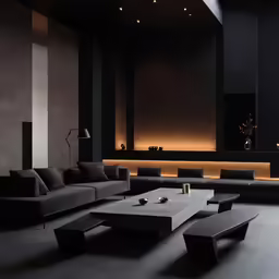this black and white room has modern couches, tables, lamps and lighting