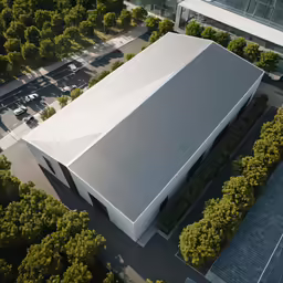 aerial view of building in front of several trees