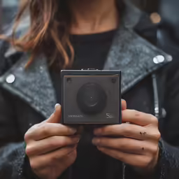 a person holding up a camera in their hands