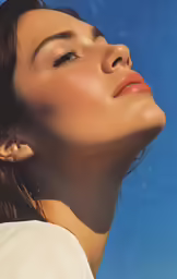 a young woman with clear, light skin and dark eyebrows