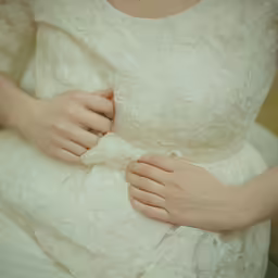 a woman that is wearing a white dress
