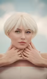 blonde model with short bangs and a straight top poses for a photo