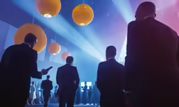 business people talk with spotlights on their walls