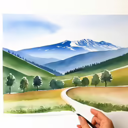 someone painting mountains in the distance with watercolics