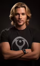 the man is posing for a portrait with his arms crossed