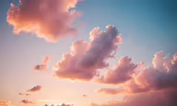a sunset over some clouds above some hills