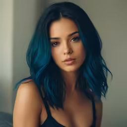 a woman with blue hair and black top