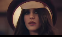 woman with big hat looking into the distance