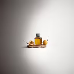 a small bottle of essential oil on a stick of fruit