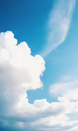 clouds hover in the blue sky with light from above