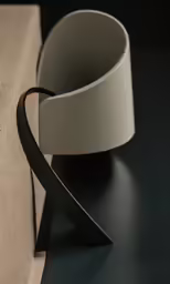a black and white curved paper holder with an eyepiece in it
