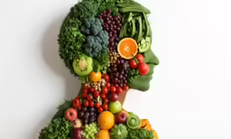 a colorful face made up of different fruits and vegetables