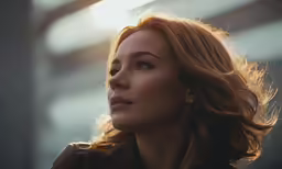 a young woman with bright eyes looks back