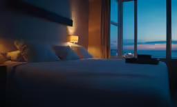 the lights are on inside of a bedroom