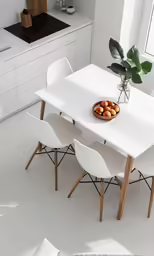a table and white chairs next to the sink
