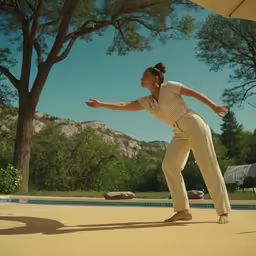 a woman standing on the floor in front of a pool