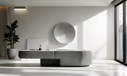 the circular mirror on the wall shows the view into a white room