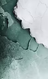 the icy water is green and white and looks as if it has melting