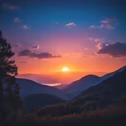 a sunset is seen over a mountain range
