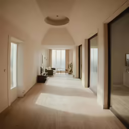 a long white and beige living room and dining area