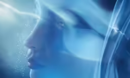a woman wearing blue in a dark, abstract image