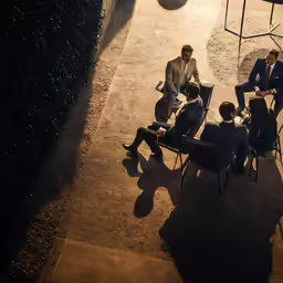 two men in suits sitting next to each other