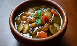 there is a bowl of vegetable soup on a table