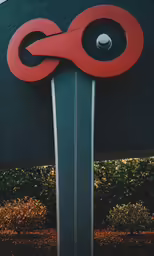 a big sign with some plants around it