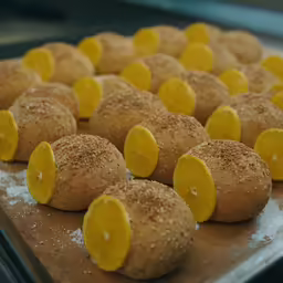 small orange slices with yellow centers are on the baking sheet