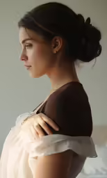 a woman standing with her hand on her shoulder
