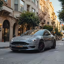 a silver car driving down a street next to tall buildings