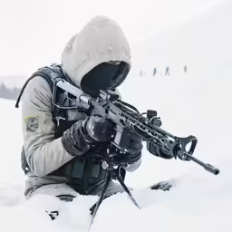 an armed soldier with a rifle is in the snow