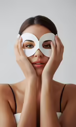 a woman with a mask on covering her face