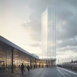 two people walk past a glass building at sunset