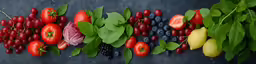 a variety of fruits and vegetables on a black surface