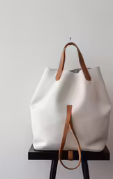 the tote bag on display on a black stand