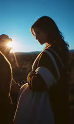 the pregnant woman is standing outside by herself