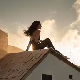woman sitting on roof with water splashing up in the air