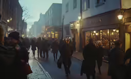 a busy street scene with lots of people walking
