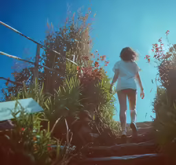 a woman walking up some steps to the water