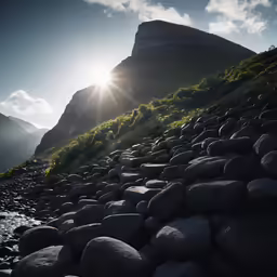 the sun is shining over a hill covered in rocks